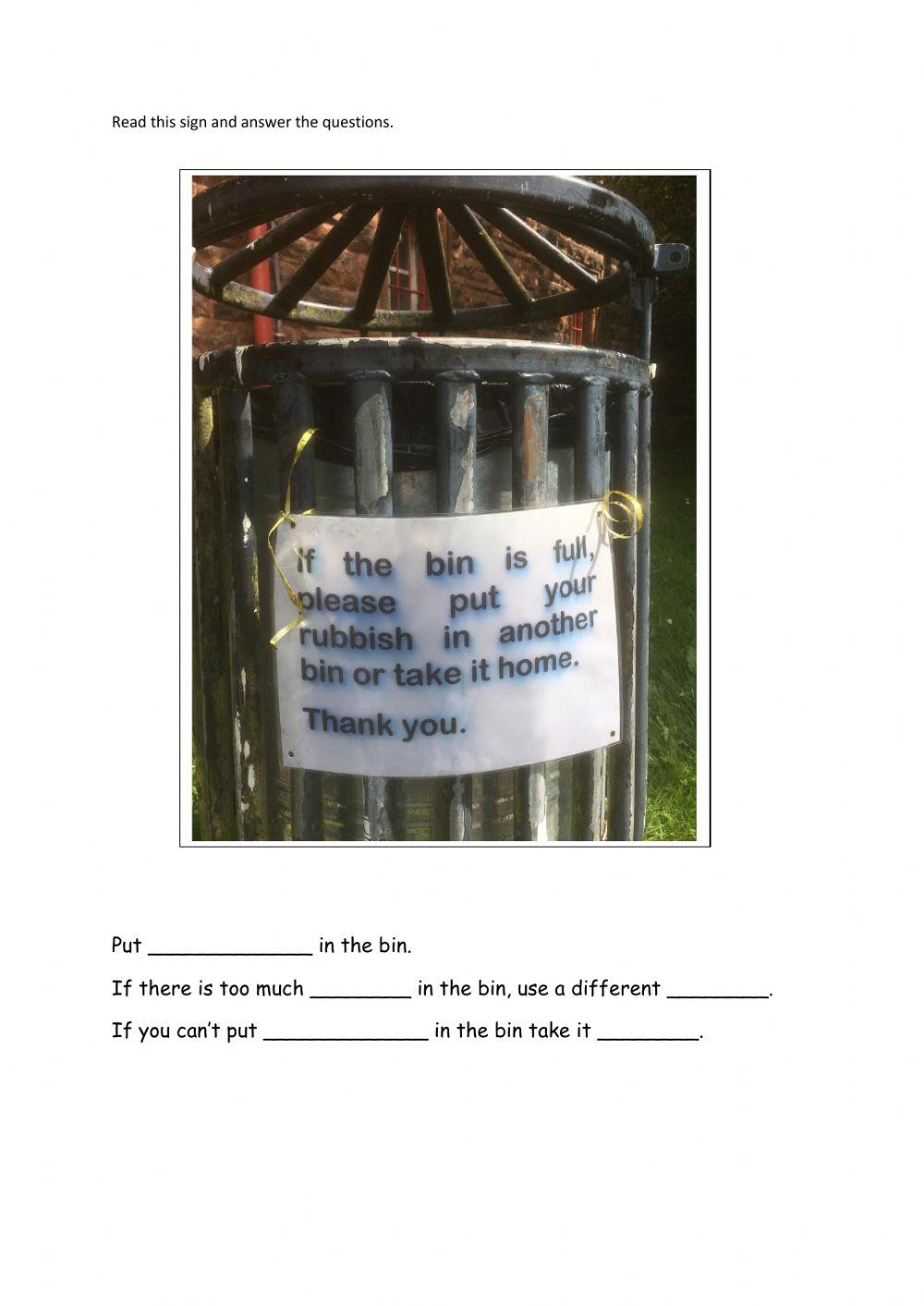 Reading a sign on a bin in a park